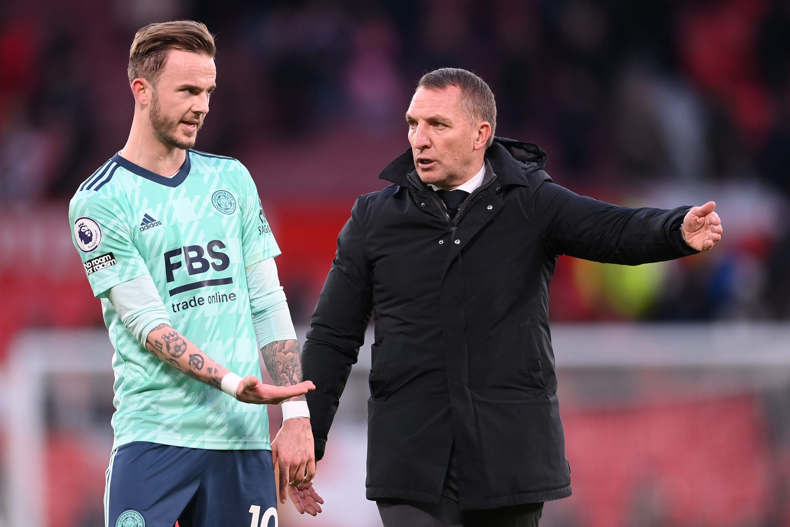 James Maddison of Leicester City interacts with Brendan Rogers.