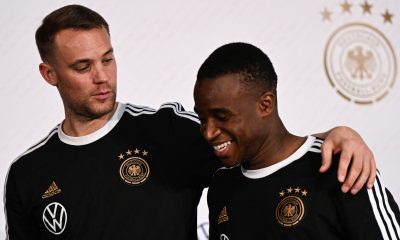 Germany's goalkeeper Manuel Neuer (L) and Germany's forward Youssoufa Moukoko leave after holding a press conference at Al Shamal Stadium in Al Shamal, north of Doha, on November 19, 2022, ahead of the Qatar 2022 World Cup football tournament. (Photo by Ina FASSBENDER / AFP) (Photo by INA FASSBENDER/AFP via Getty Images)