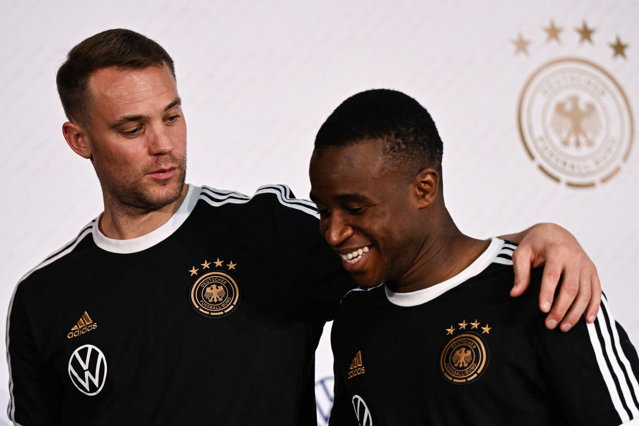 Germany's goalkeeper Manuel Neuer (L) and Germany's forward Youssoufa Moukoko leave after holding a press conference at Al Shamal Stadium in Al Shamal, north of Doha, on November 19, 2022, ahead of the Qatar 2022 World Cup football tournament. (Photo by Ina FASSBENDER / AFP) (Photo by INA FASSBENDER/AFP via Getty Images)