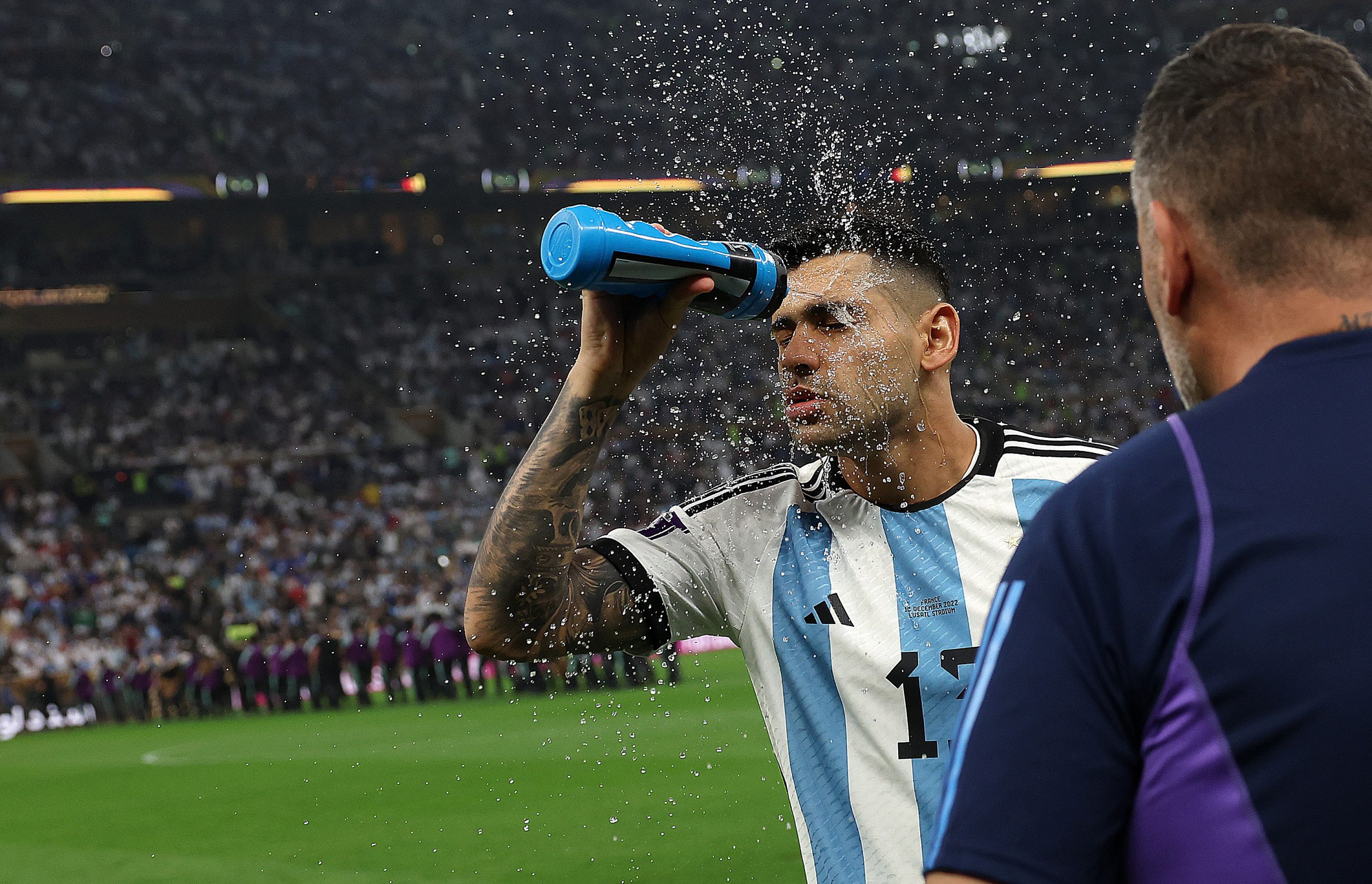 Cristian Romero of Argentina sprays his face with water before the FIFA World Cup Qatar 2022 Final match between Argentina and France at Lusail Stadium on December 18, 2022 in Lusail City, Qatar. (Photo by Julian Finney/Getty Images)