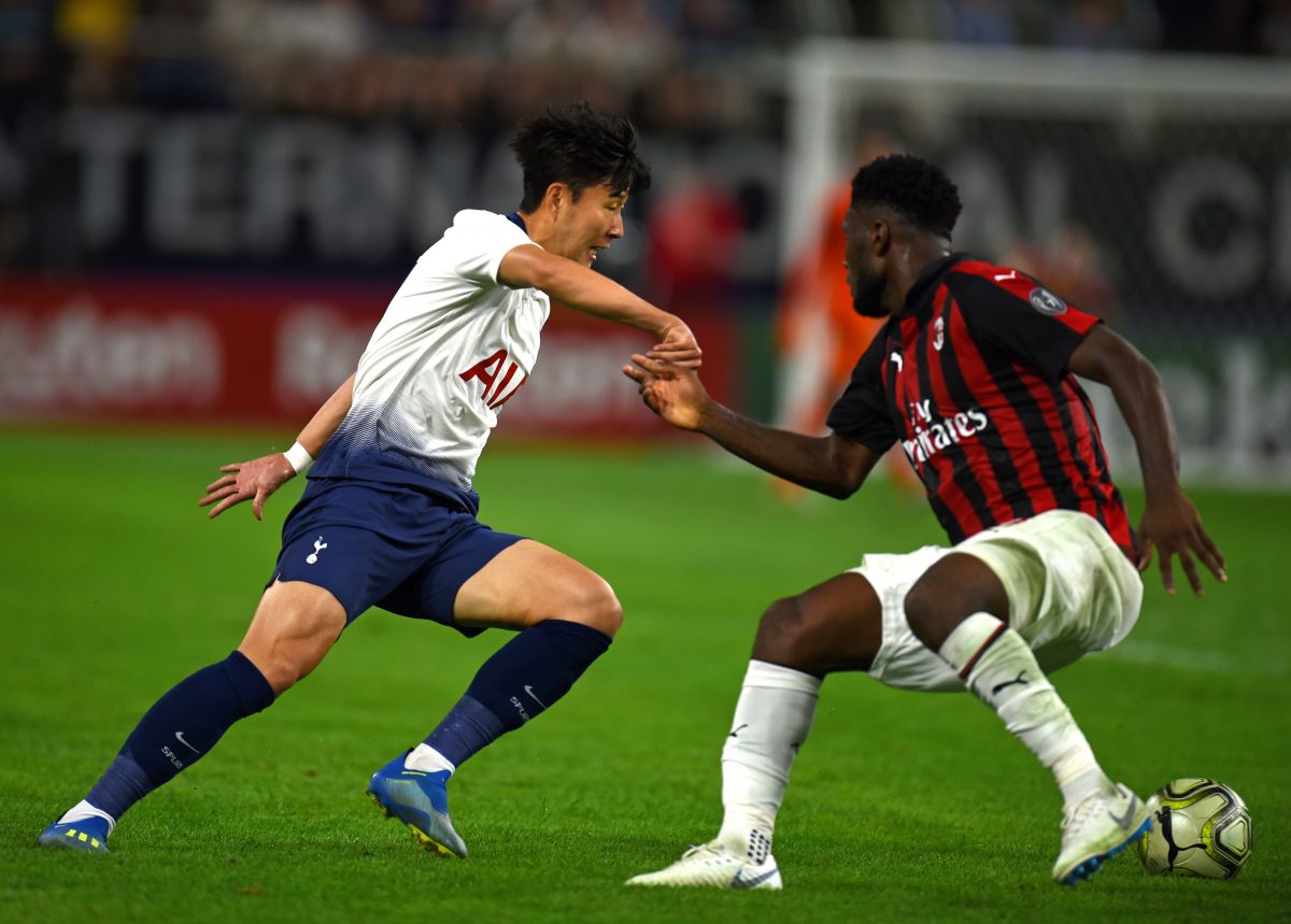 Tottenham Hotspur's Son Heung-Min vies for the ball with AC Milan's Franck Kessie.