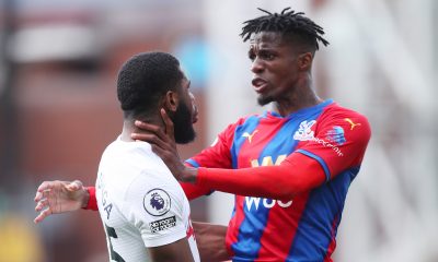 Wilfried Zaha of Crystal Palace clashes with Japhet Tanganga of Tottenham Hotspur during the Premier League match between Crystal Palace and Tottenham Hotspur at Selhurst Park on September 11, 2021 in London, England. (Photo by Alex Morton/Getty Images)