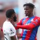 Wilfried Zaha of Crystal Palace clashes with Japhet Tanganga of Tottenham Hotspur during the Premier League match between Crystal Palace and Tottenham Hotspur at Selhurst Park on September 11, 2021 in London, England. (Photo by Alex Morton/Getty Images)