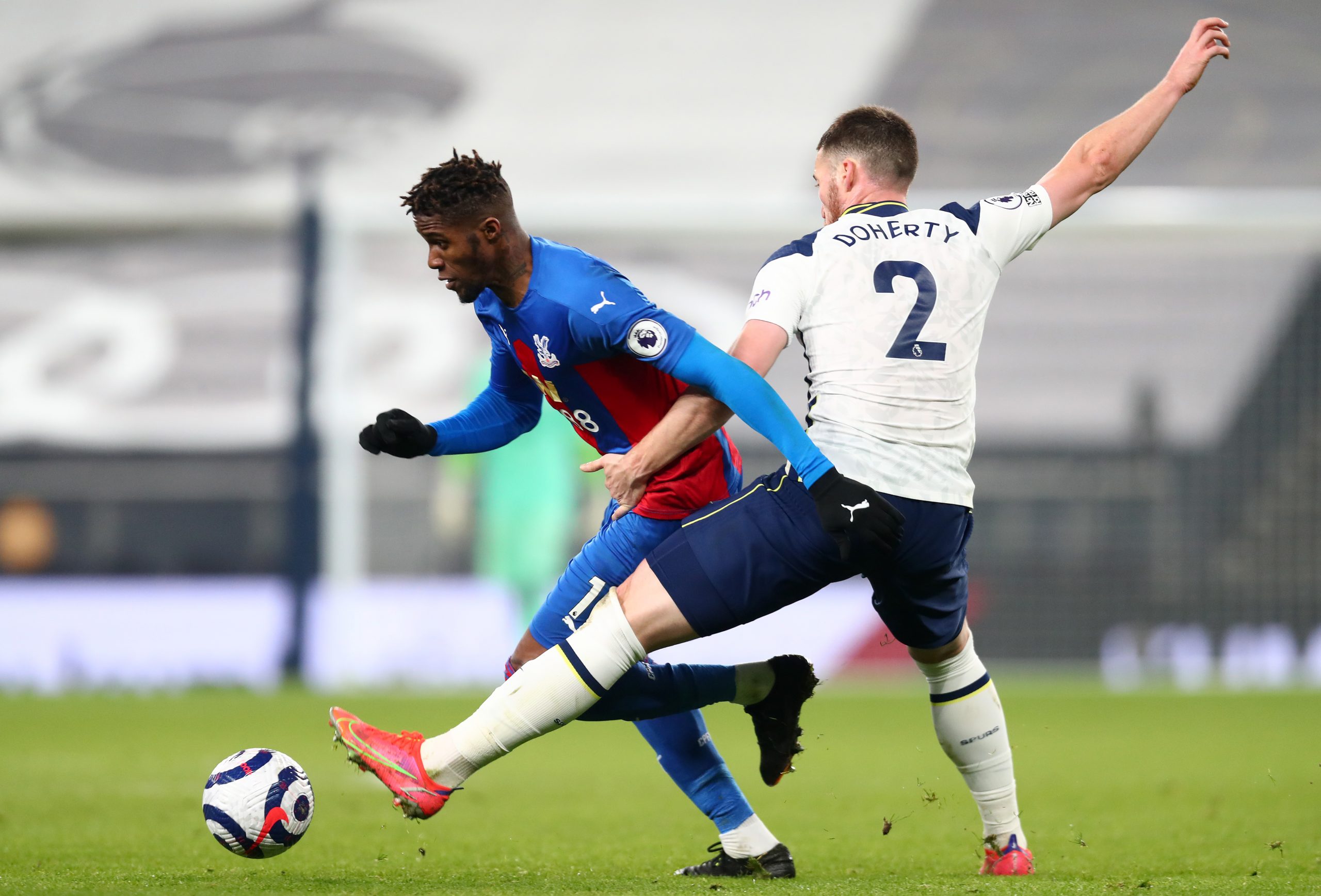 Wilfried Zaha of Crystal Palace is challenged by Matt Doherty of Tottenham Hotspur. 