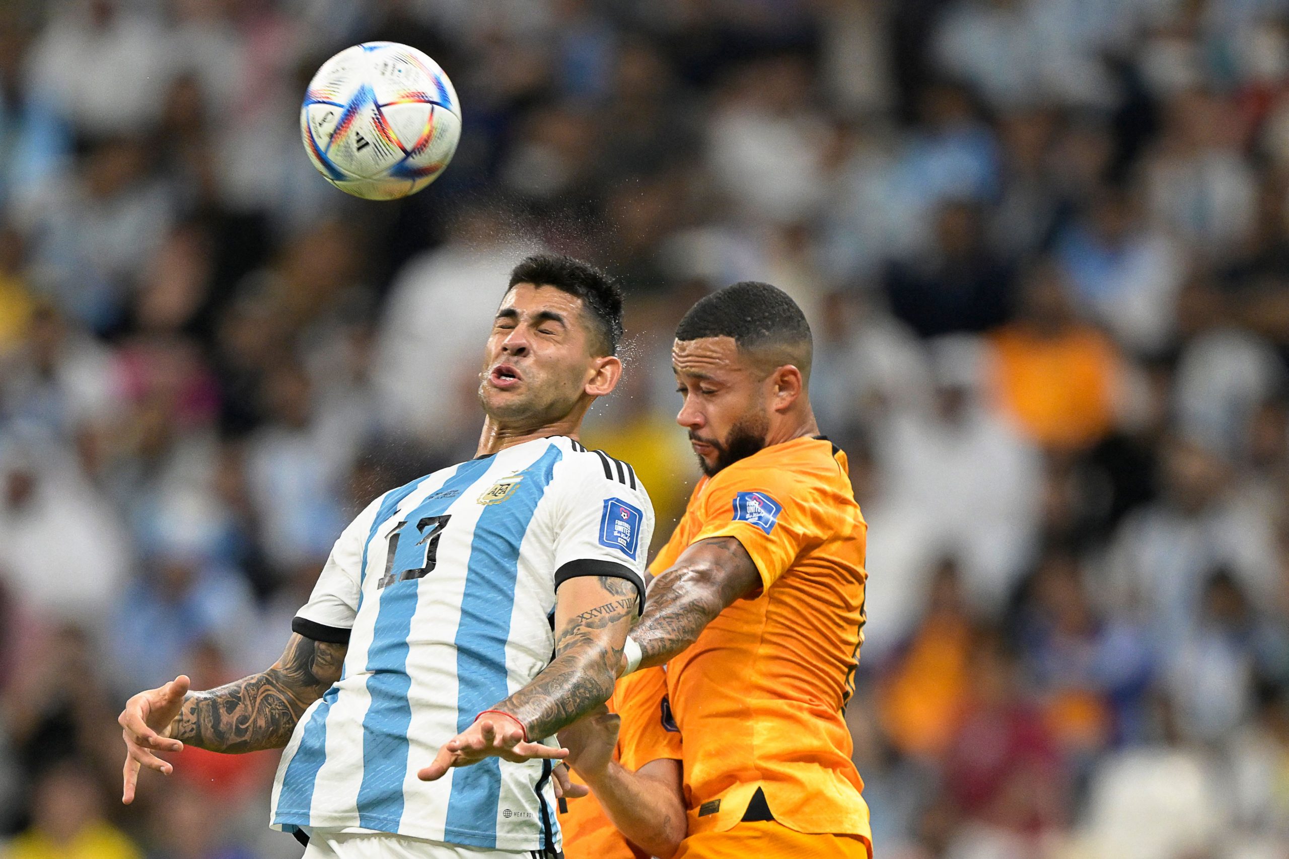 Argentina's defender #13 Cristian Romero fights for the ball with Netherlands' forward #10 Memphis Depay during the Qatar 2022 World Cup quarter-final football match between The Netherlands and Argentina at Lusail Stadium, north of Doha on December 9, 2022. (Photo by JUAN MABROMATA / AFP) (Photo by JUAN MABROMATA/AFP via Getty Images)