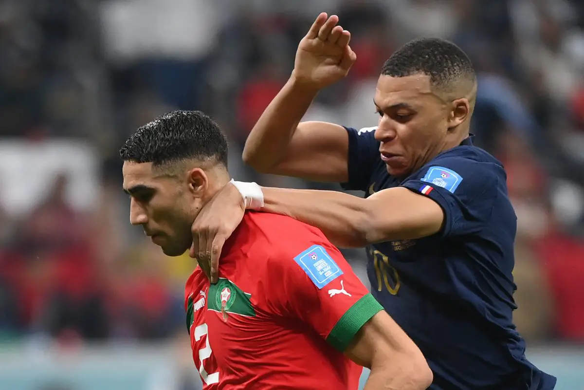 France's Kylian Mbappe fights for the ball with Morocco's Achraf Hakimi. 