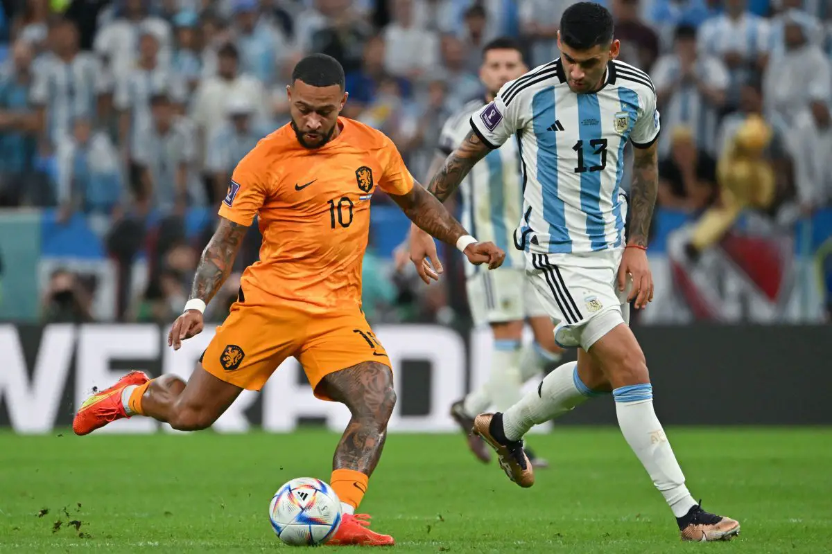 Netherlands' forward Memphis Depay is marked by Argentina's Cristian Romero. 