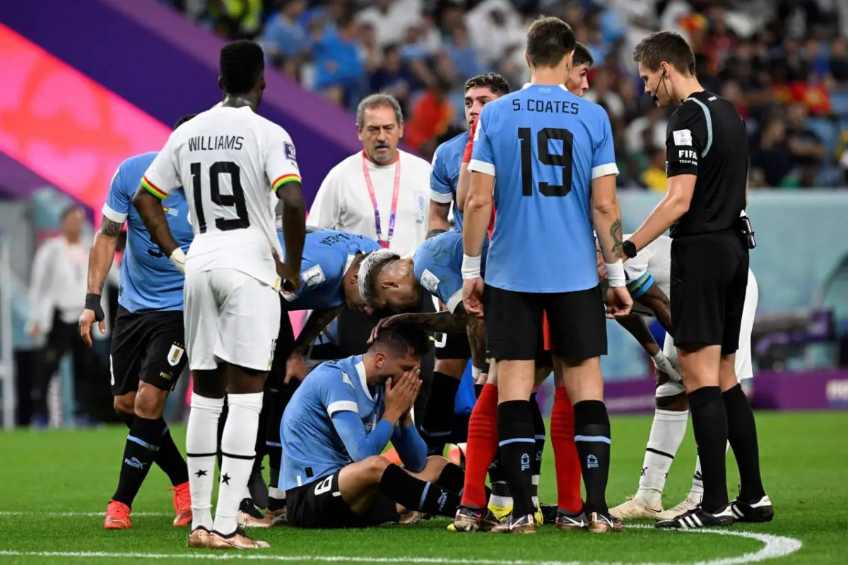 Rodrigo Bentancur surrounded by teammates against Ghana. (Photo by ALFREDO ESTRELLA/AFP via Getty Images)