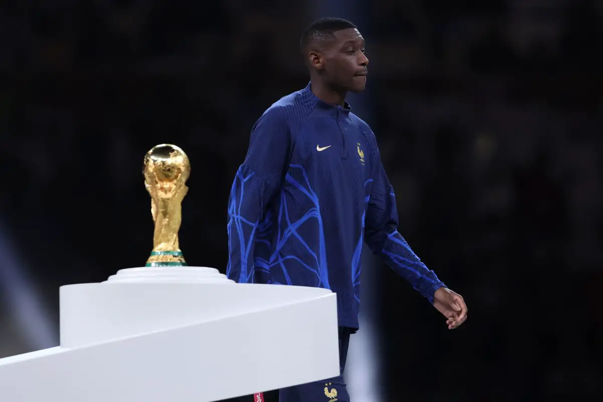 Randal Kolo Muani of France walks past the FIFA World Cup trophy. (Photo by Clive Brunskill/Getty Images)