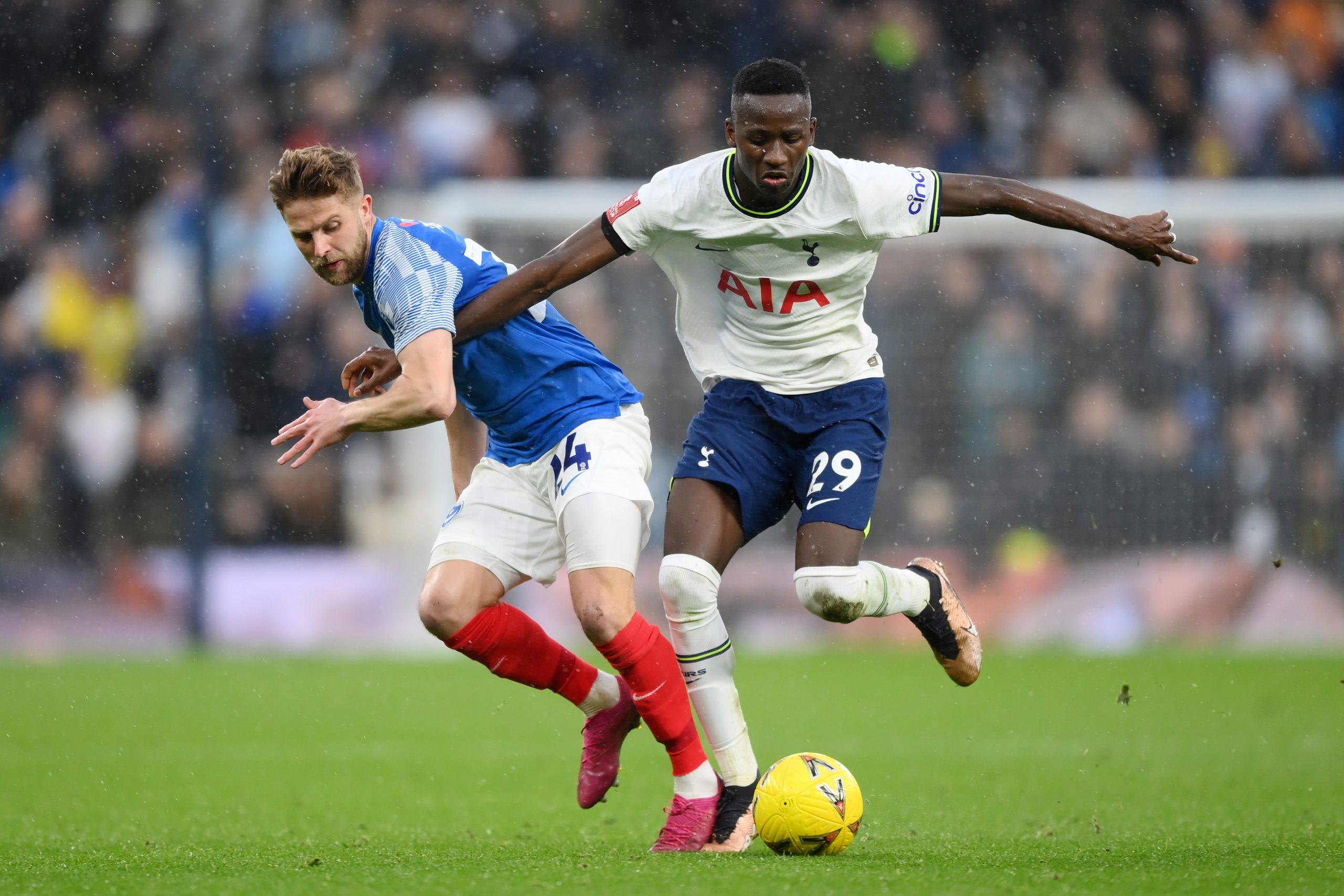 Pape Matar Sarr of Tottenham Hotspur battles for possession with Michael Jacobs of Portsmouth during the Emirates FA Cup Third Round match between Tottenham Hotspur and Portsmouth FC at Tottenham Hotspur Stadium on January 07, 2023 in London, England. (Photo by Shaun Botterill/Getty Images)