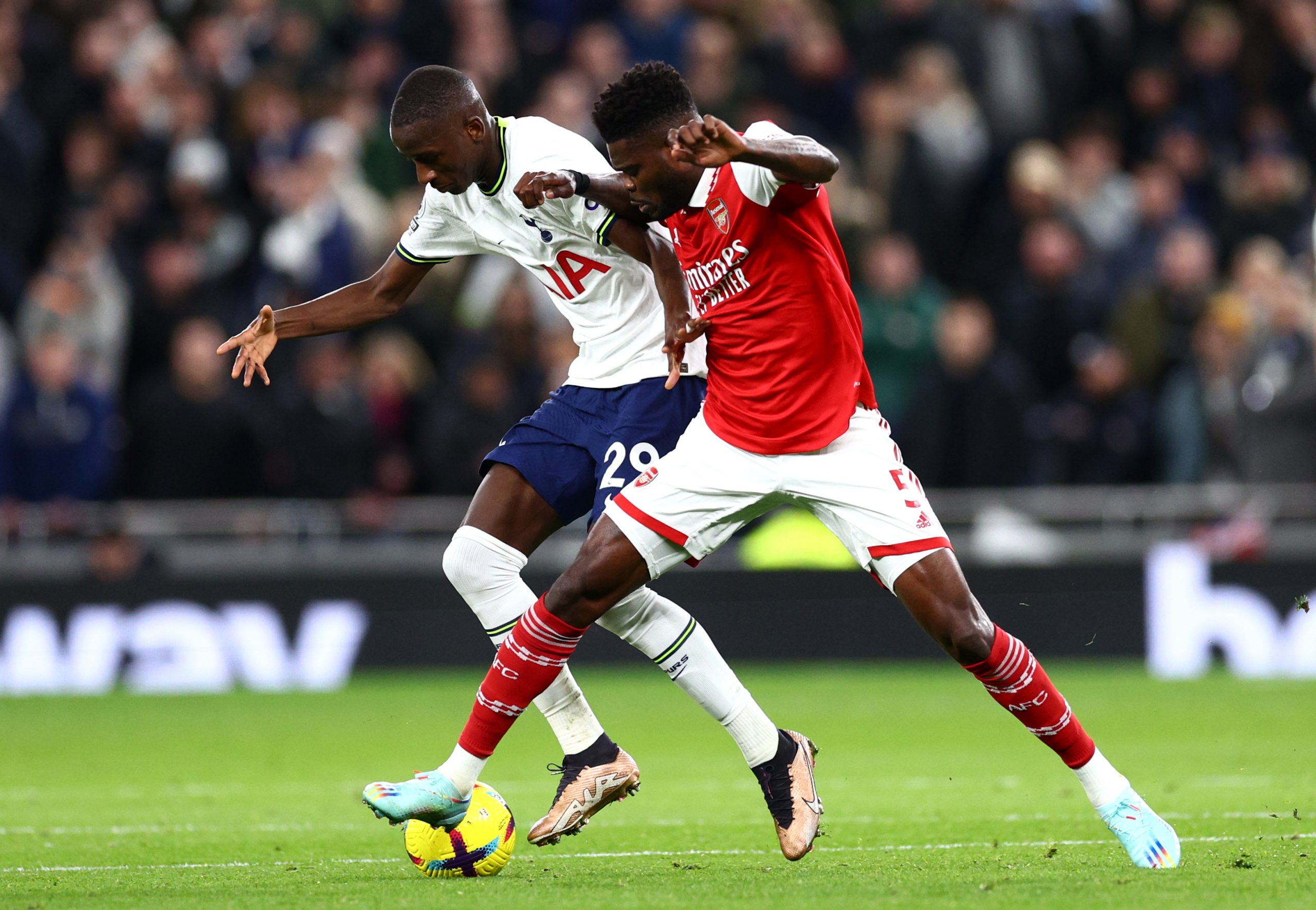 Pape Matar Sarr of Tottenham Hotspur battles for possession with Thomas Partey of Arsenal during the Premier League match between Tottenham Hotspur and Arsenal FC at Tottenham Hotspur Stadium on January 15, 2023 in London, England. (Photo by Clive Rose/Getty Images)