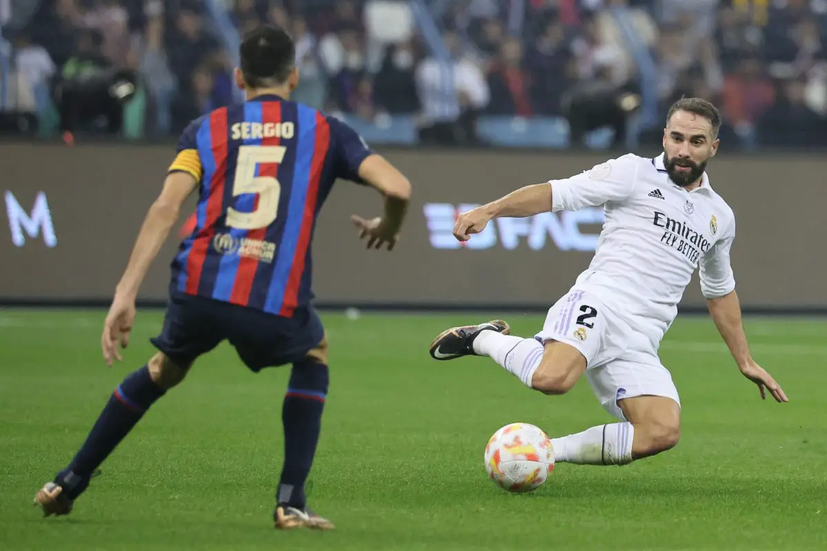 Real Madrid's Daniel Carvajal in action against Barcelona's Sergio Busquets. 