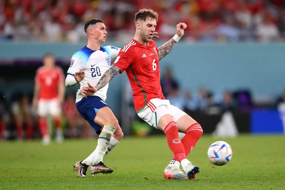 Joe Rodon of Wales is challenged by Phil Foden of England. 