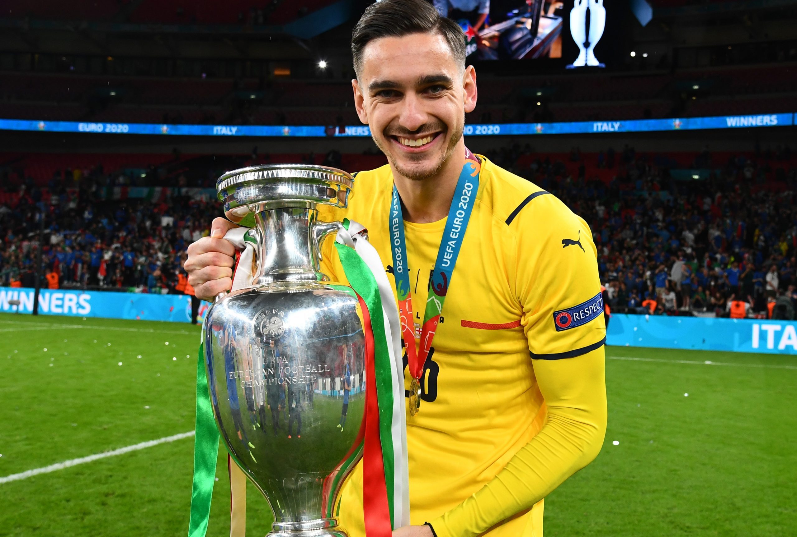 Alex Meret of Italy celebrates with The Henri Delaunay Trophy following his team's victory in the UEFA Euro 2020 Championship Final against England.