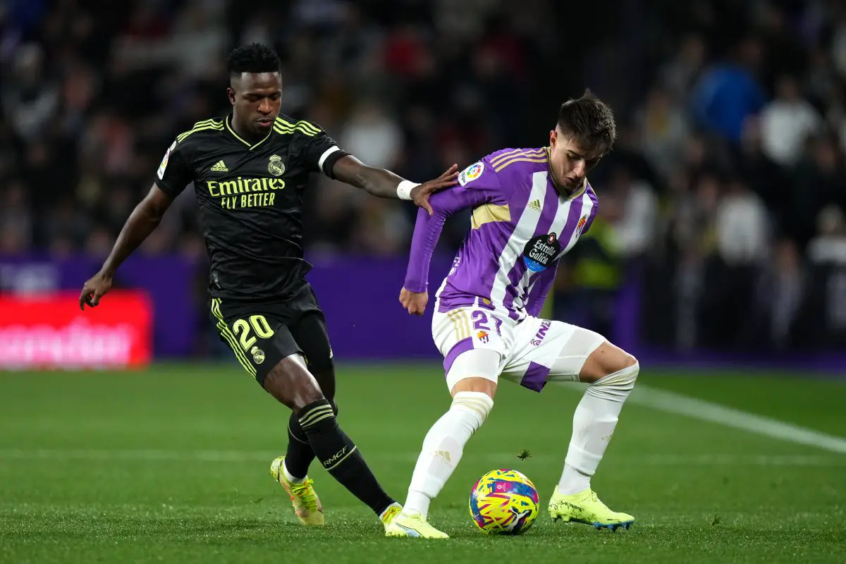 Ivan Fresneda of Real Valladolid CF is challenged by Vinicius Junior of Real Madrid. 