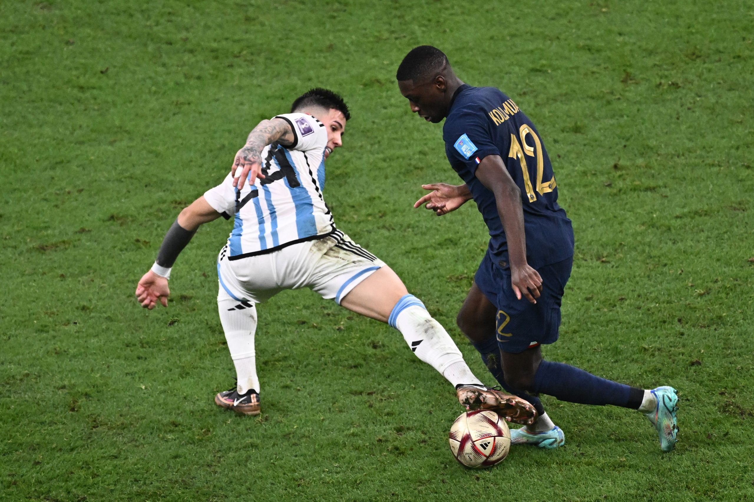 Argentina's Enzo Fernandez battles for possession with Randal Kolo Muani of France. (Photo by JEWEL SAMAD/AFP via Getty Images)