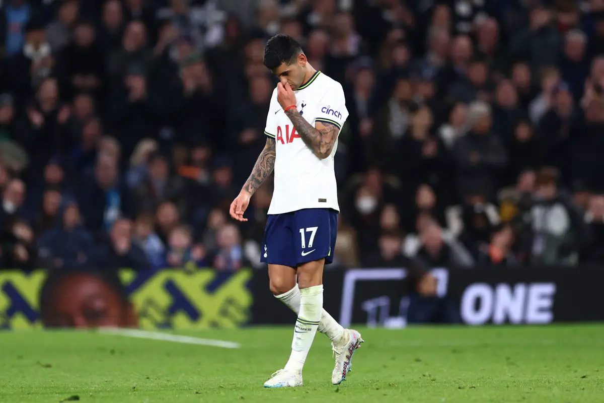 Cristian Romero of Tottenham Hotspur leaves the pitch after being red carded against Manchester City.