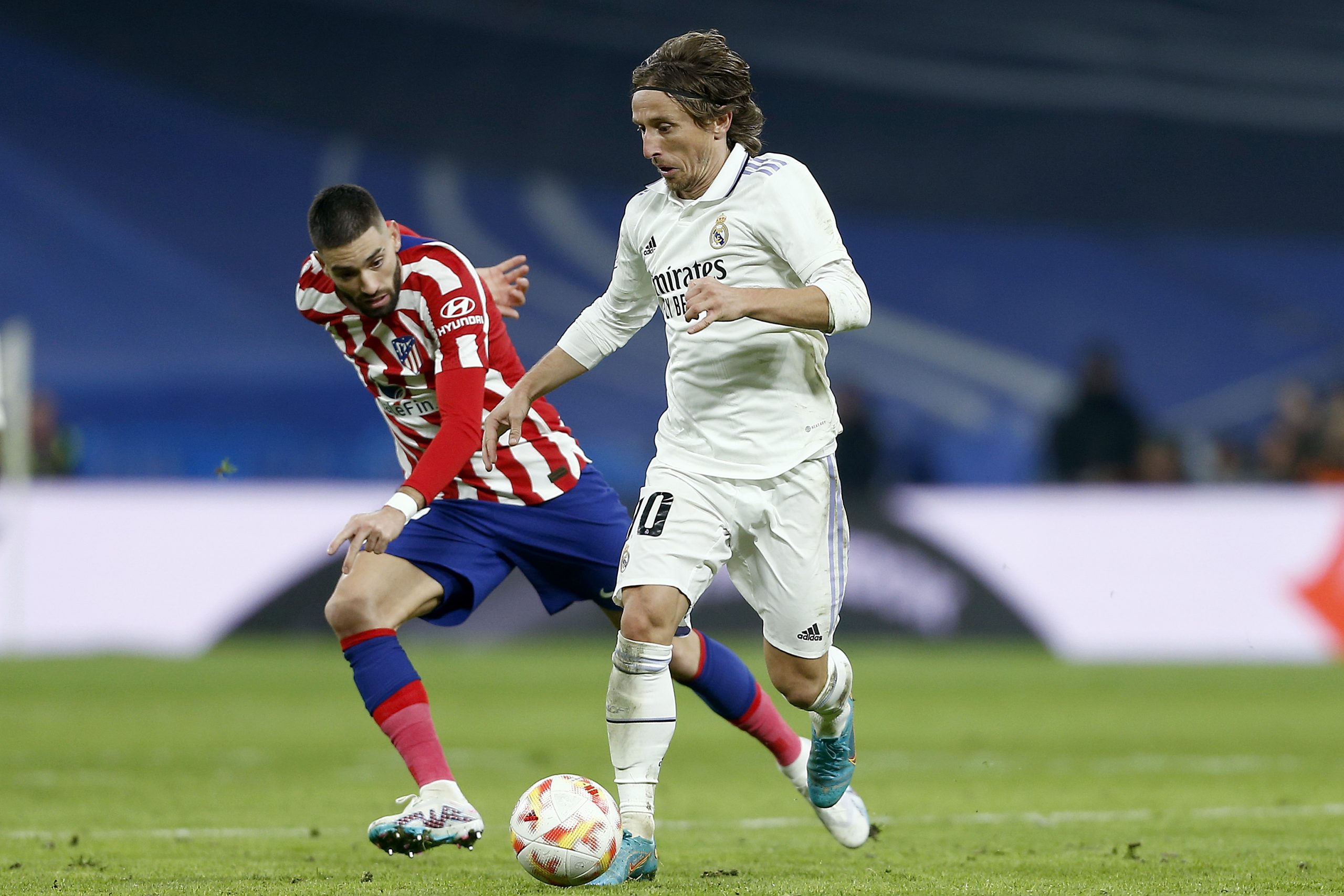 Luka Modric of Real Madrid being followed by Yannick Carrasco of Atletico de Madrid during the Copa Del Rey Quarter Final match between Real Madrid and Atletico de Madrid at Estadio Santiago Bernabeu on January 26, 2023 in Madrid, Spain. (Photo by Florencia Tan Jun/Getty Images)