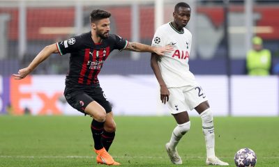 Pape Matar Sarr of Tottenham Hotspur passes the ball whilst under pressure from Olivier Giroud of AC Milan.