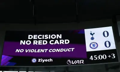 The LED screen shows the VAR decision to rule out the red card shown to Hakim Ziyech of Chelsea against Spurs.