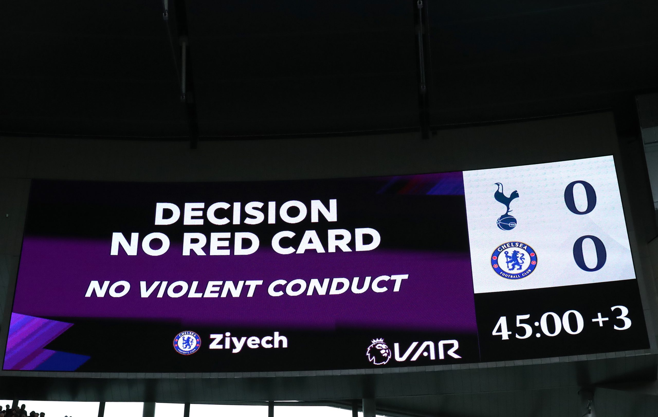 The LED screen shows the VAR decision to rule out the red card shown to Hakim Ziyech of Chelsea against Spurs.