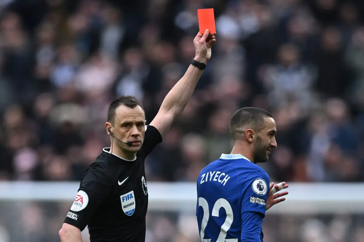 English referee Stuart Attwell (L) shows a red card to Chelsea's Moroccan midfielder Hakim Ziyech (R), later rescinded during the English Premier League football match between Tottenham Hotspur and Chelsea at Tottenham Hotspur Stadium in London, on February 26, 2023