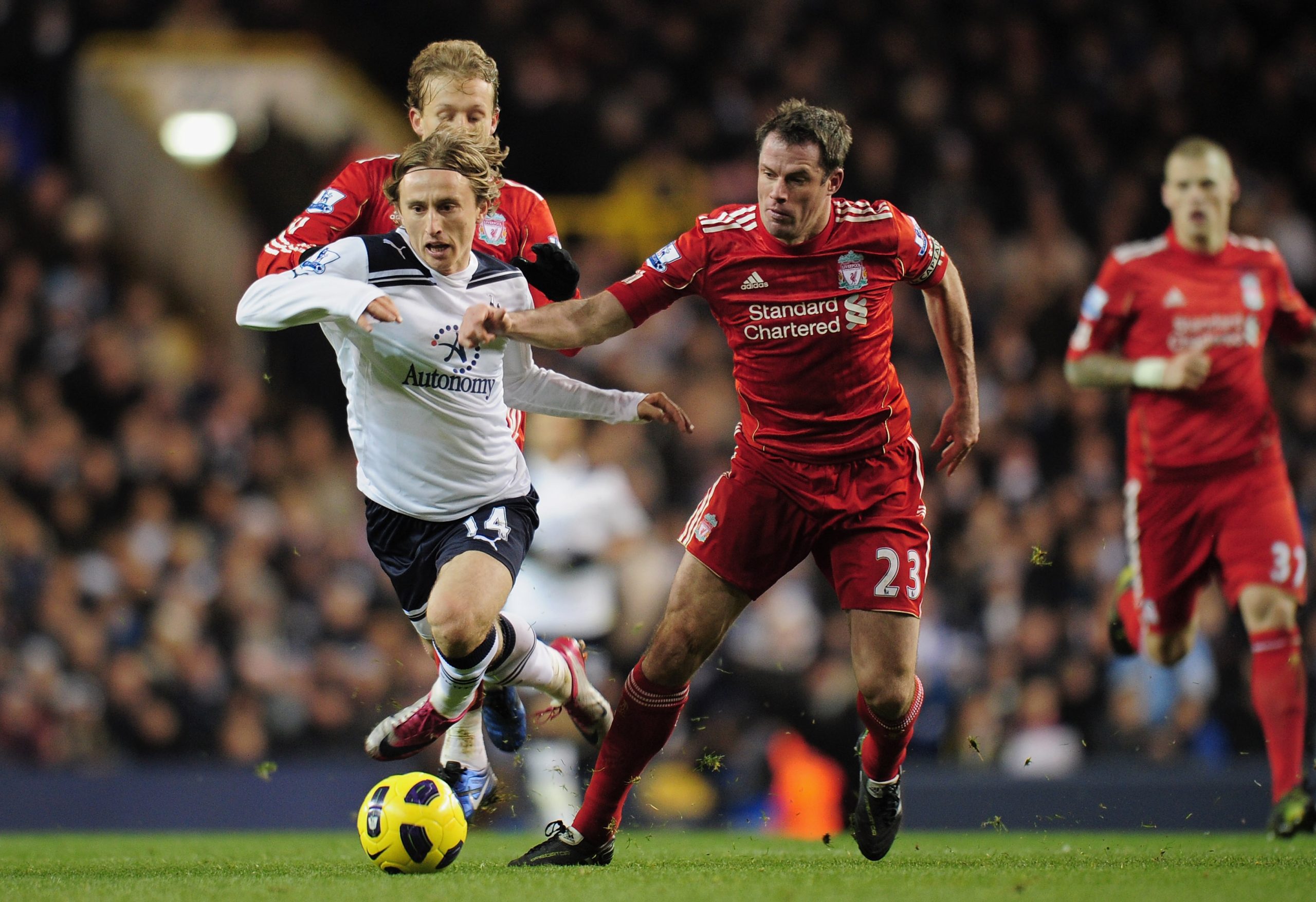 Luka Modric of Tottenham Hotspur is tackled by Jamie Carragher of Liverpool - November 2010.