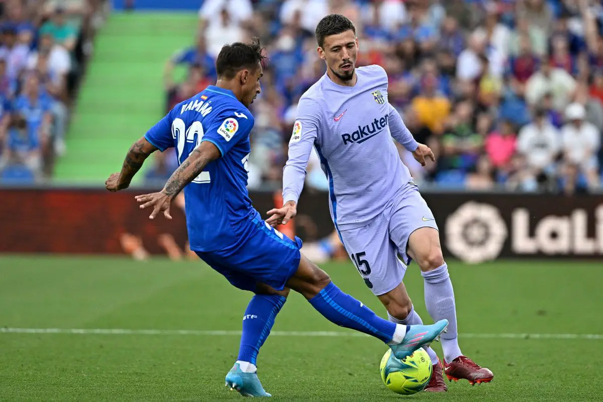 Getafe's Uruguayan defender Damian Suarez fights for the ball with Barcelona's French defender Clement Lenglet.