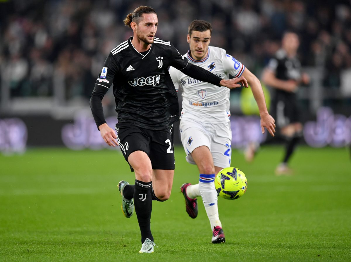 Adrien Rabiot of Juventus runs with the ball under pressure from Harry Winks of UC Sampdoria.