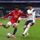 Marcus Rashford of Manchester United attempts a cross whilst under pressure from Son Heung-Min of Tottenham Hotspur.