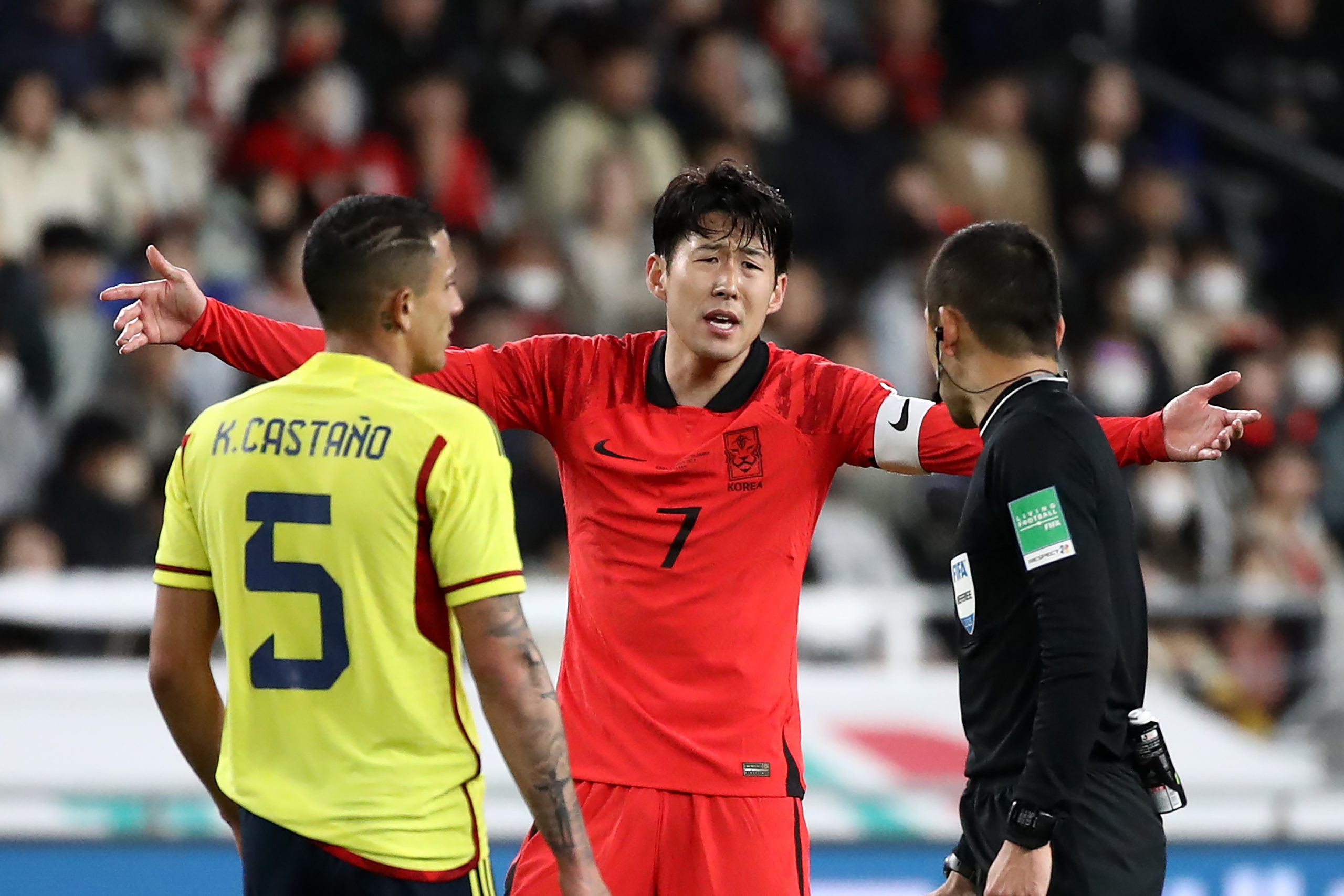 Son Heung-min of South Korea talks with referee Iida Jumpei against Colombia.