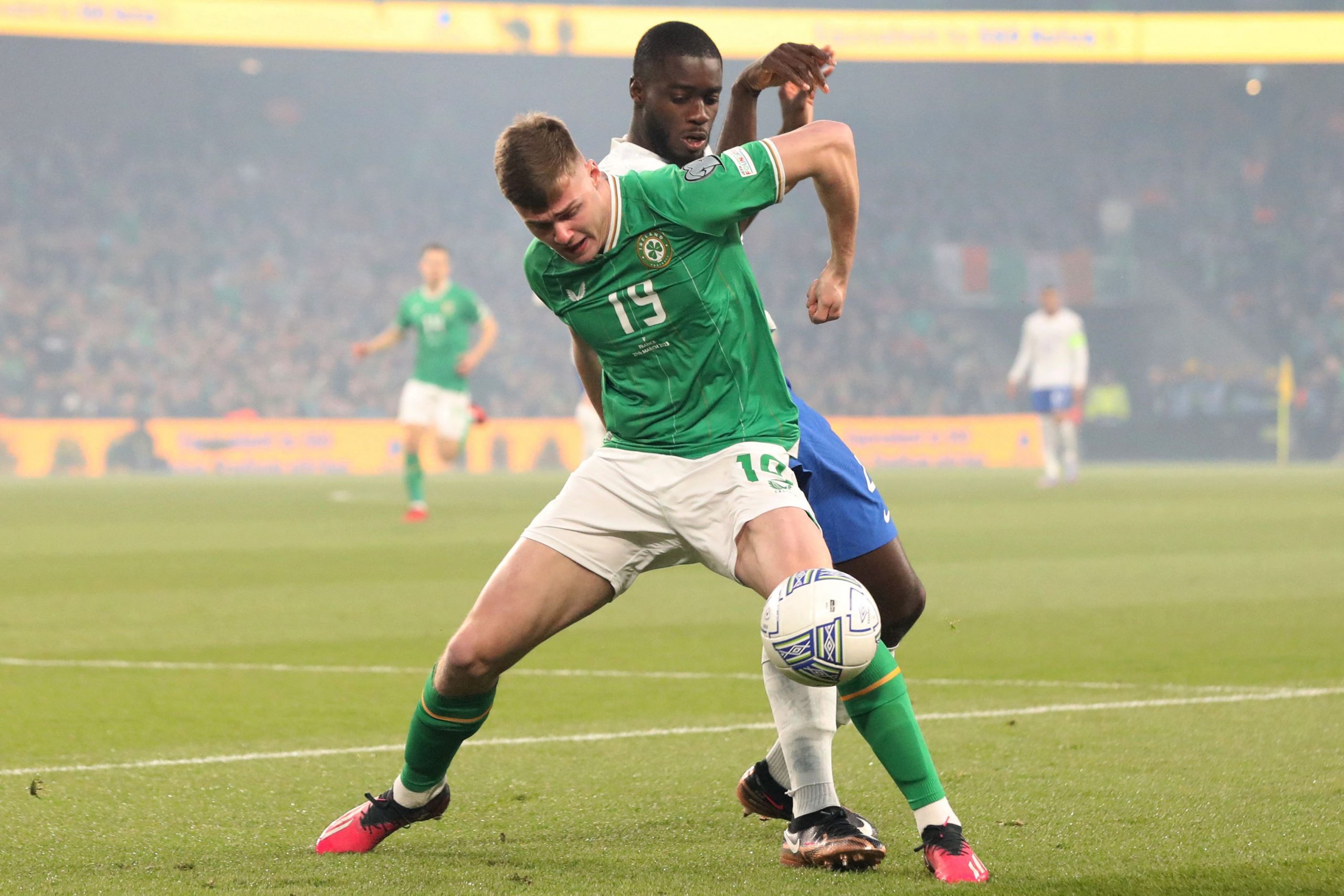 Republic of Ireland's striker Evan Ferguson vies with France's defender Dayot Upamecano.