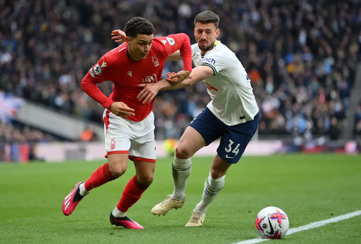 Clement Lenglet of Tottenham Hotspur tackles Brennan Johnson of Nottingham Forest.