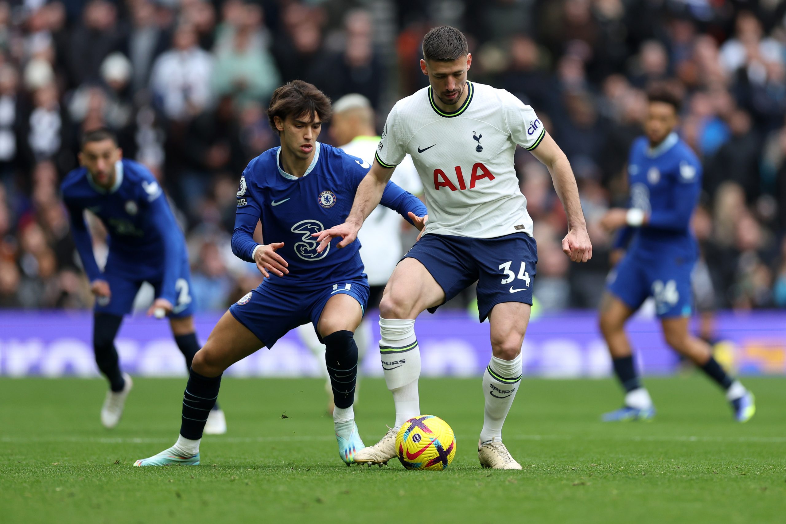 Clement Lenglet of Tottenham Hotspur carries the ball as Joao Felix of Chelsea watches on. (Photo by Catherine Ivill/Getty Images)