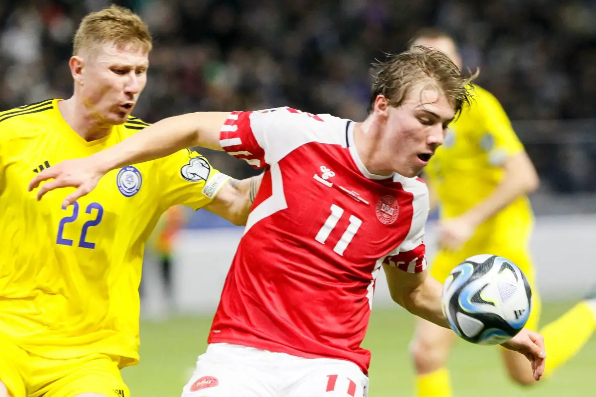 Denmark's forward Rasmus Hojlund (R) vies for the ball with Kazakhstan's defender Aleksandr Marochkin. 