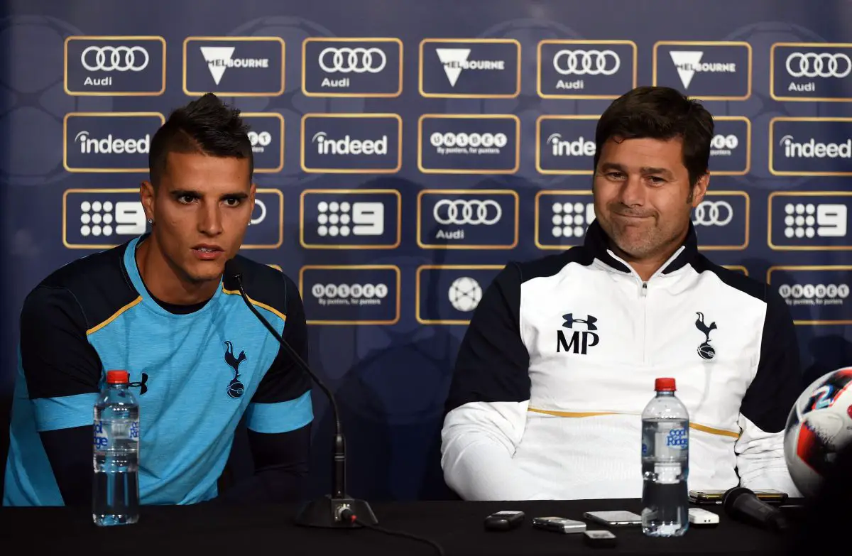 Tottenham team manager Mauricio Pochettino gestures as midfielder Erik Lamela (L) answers a question during a press conference. 