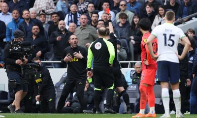 Referee Stuart Attwell shows a red card to Cristian Stellini of Tottenham Hotspur.