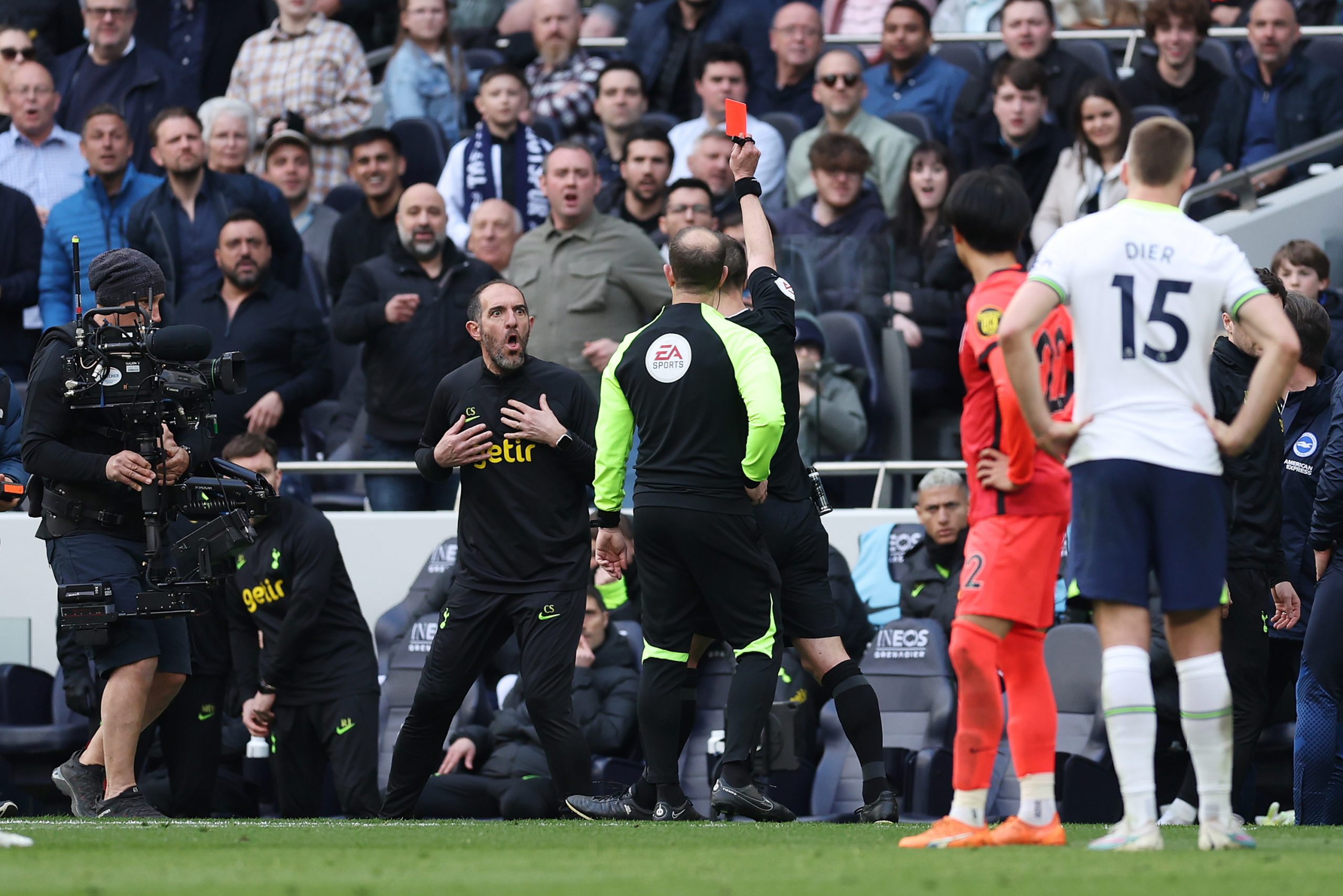 Referee Stuart Attwell shows a red card to Cristian Stellini of Tottenham Hotspur.