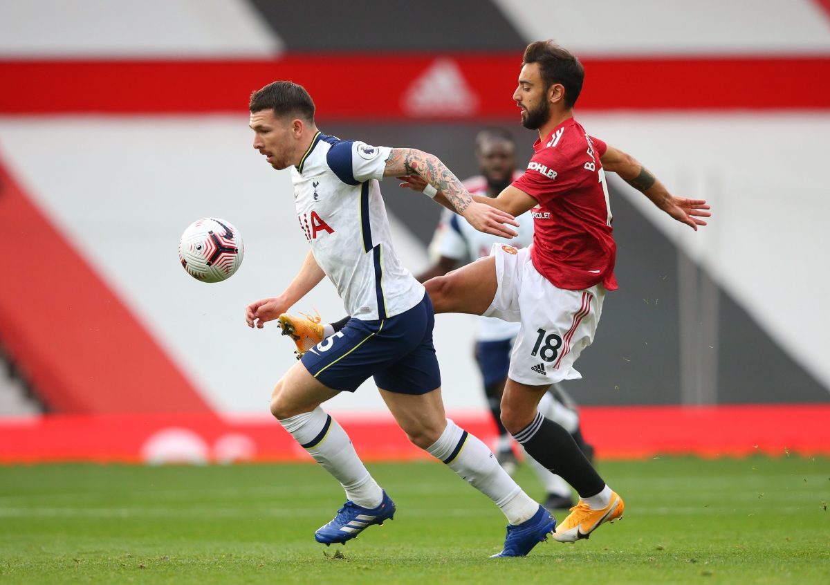 Tottenham Hotspur's Danish midfielder Pierre-Emile Hojbjerg is challenged by Manchester United's Portuguese midfielder Bruno Fernandes. 