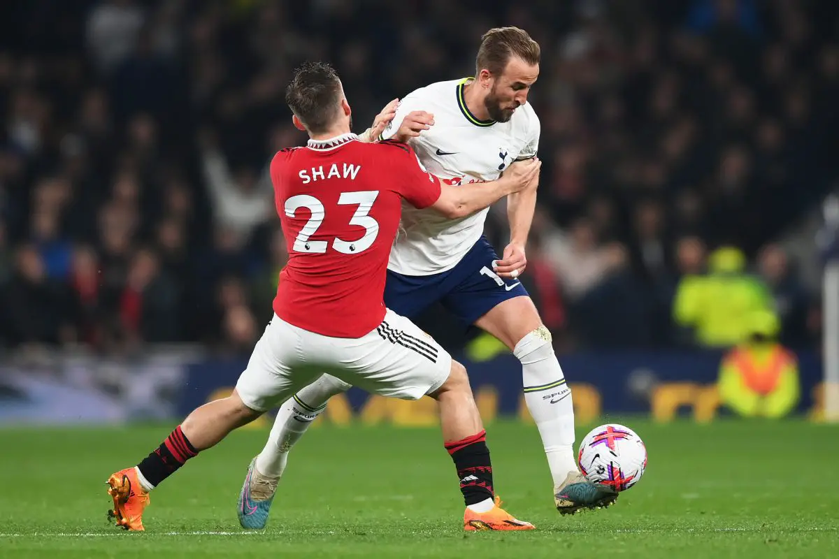 Harry Kane of Tottenham Hotspur Hotspur is challenged by Luke Shaw of Manchester United. 