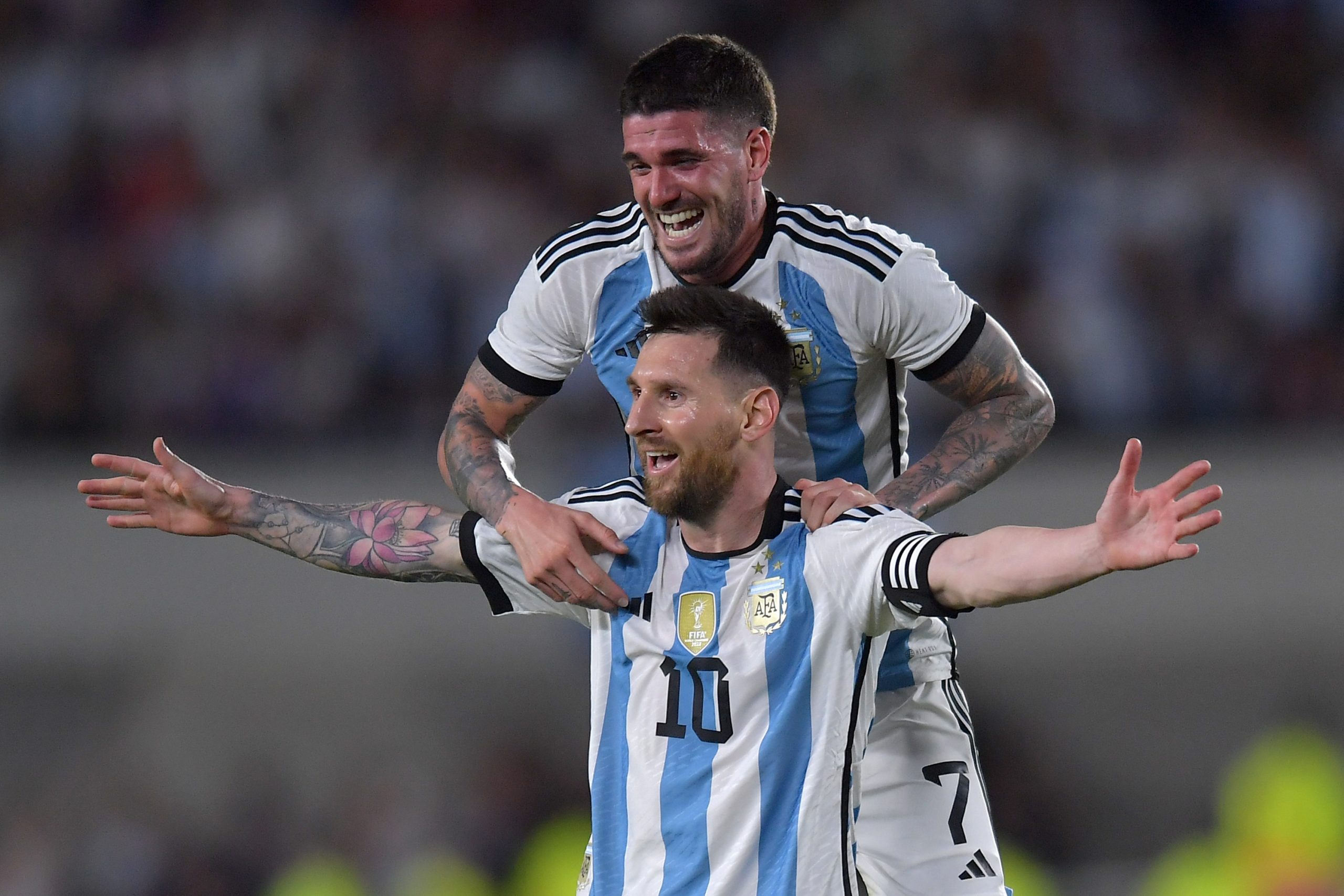 Lionel Messi of Argentina celebrates after scoring with teammate Rodrigo De Paul.