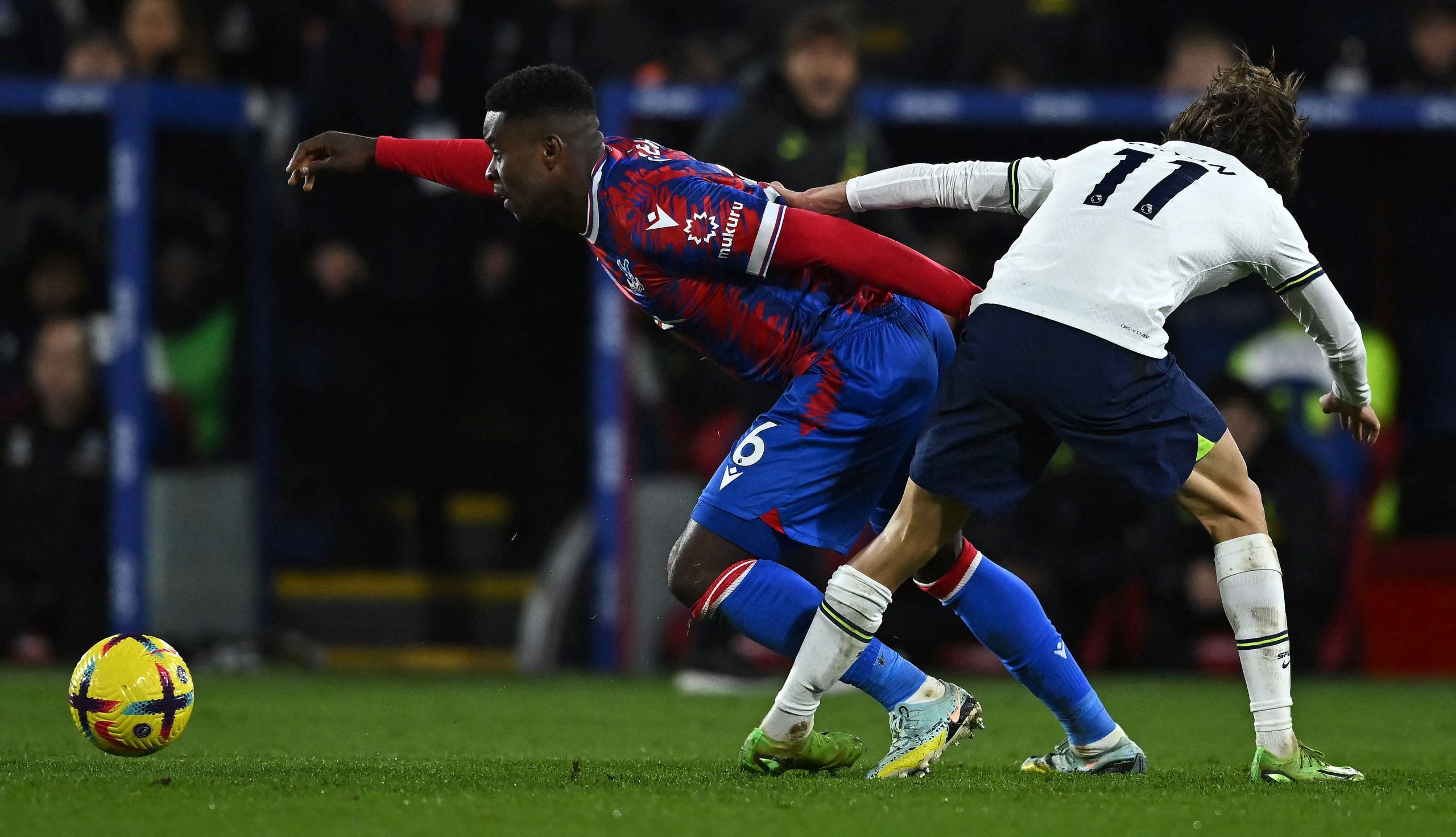 Crystal Palace's English defender Marc Guehi and Tottenham Hotspur's Bryan Gil compete for the ball.
