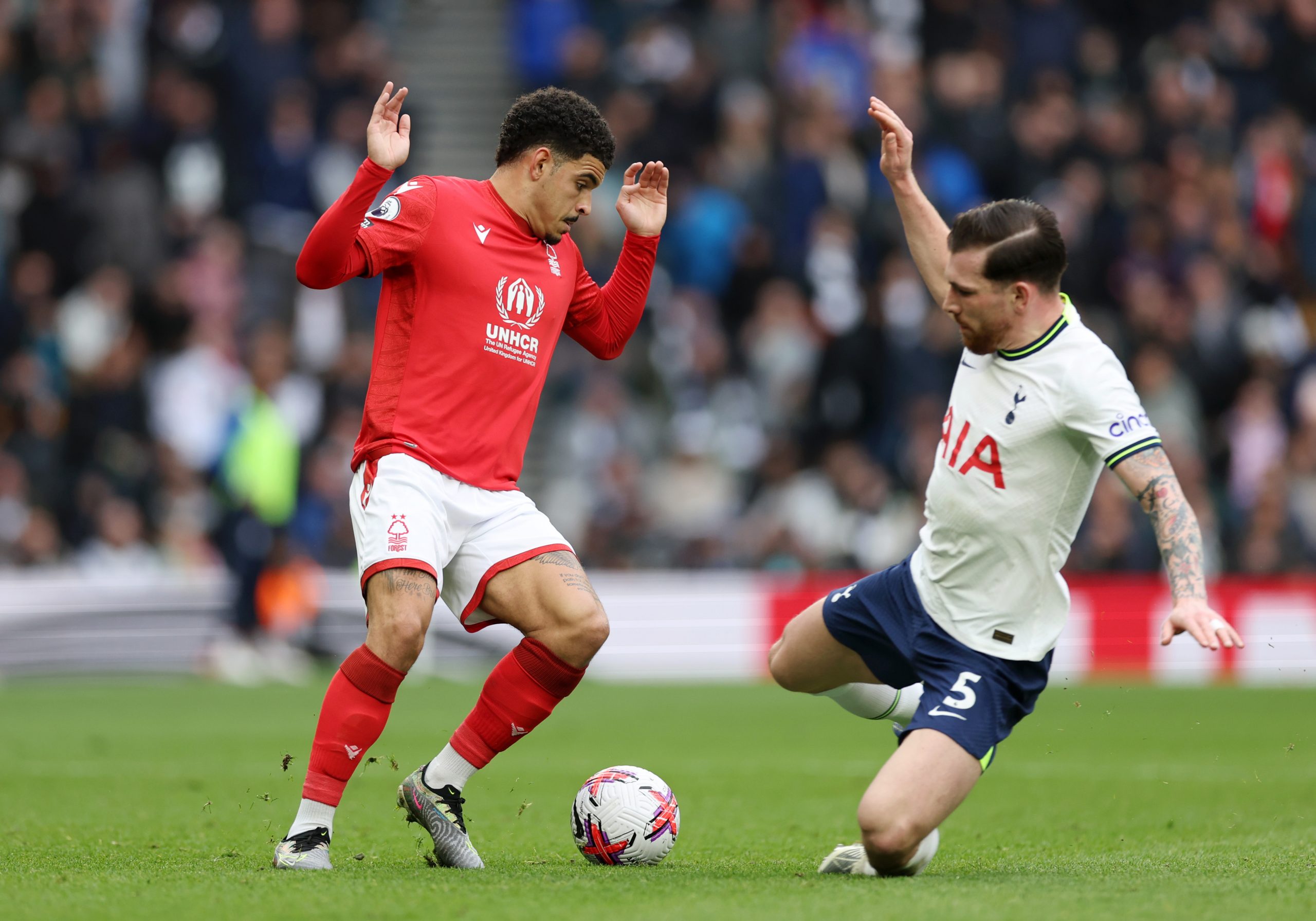 Morgan Gibbs-White of Nottingham Forest is challenged by Pierre-Emile Hojbjerg of Tottenham Hotspur.