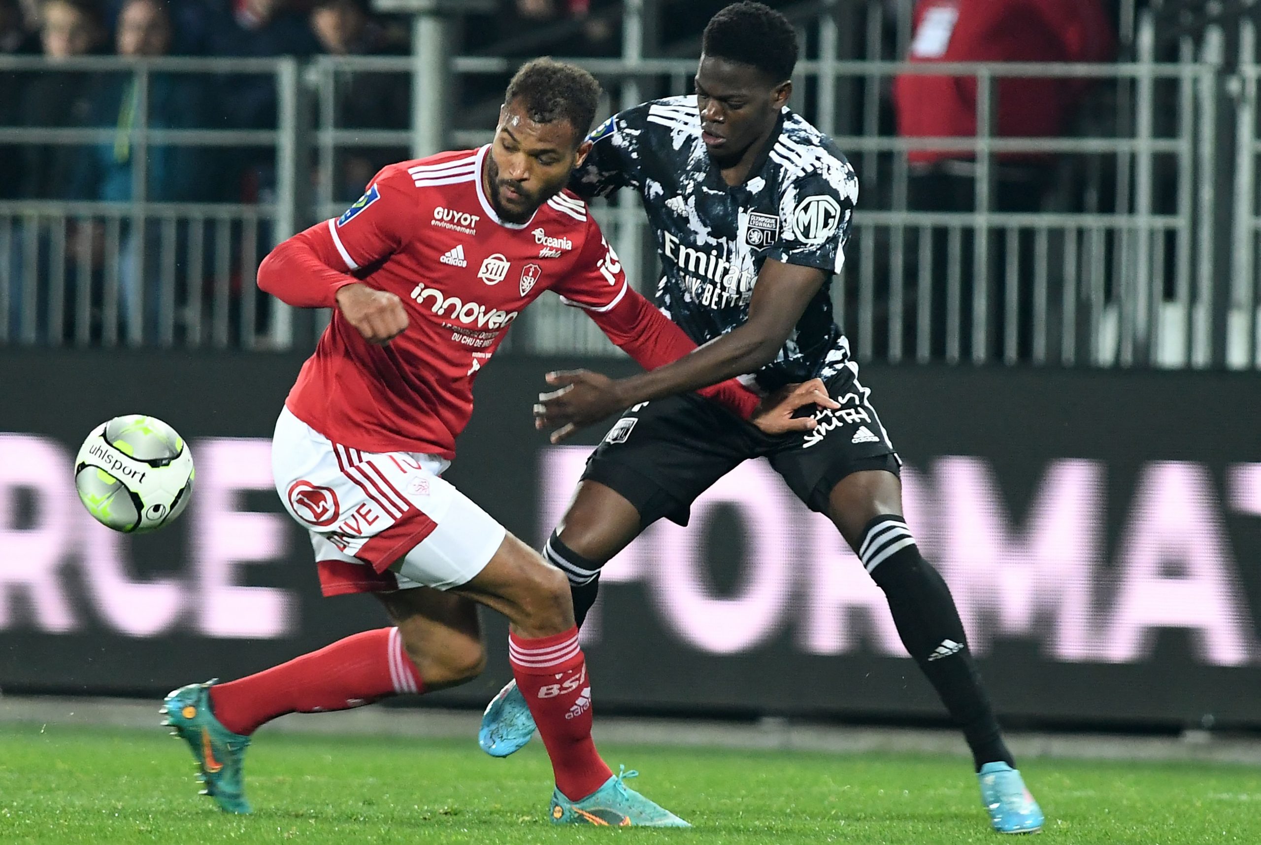 Brest's Beninese forward Steve Mounie (L) fights for the ball with Lyon's French defender Castello Lukeba.