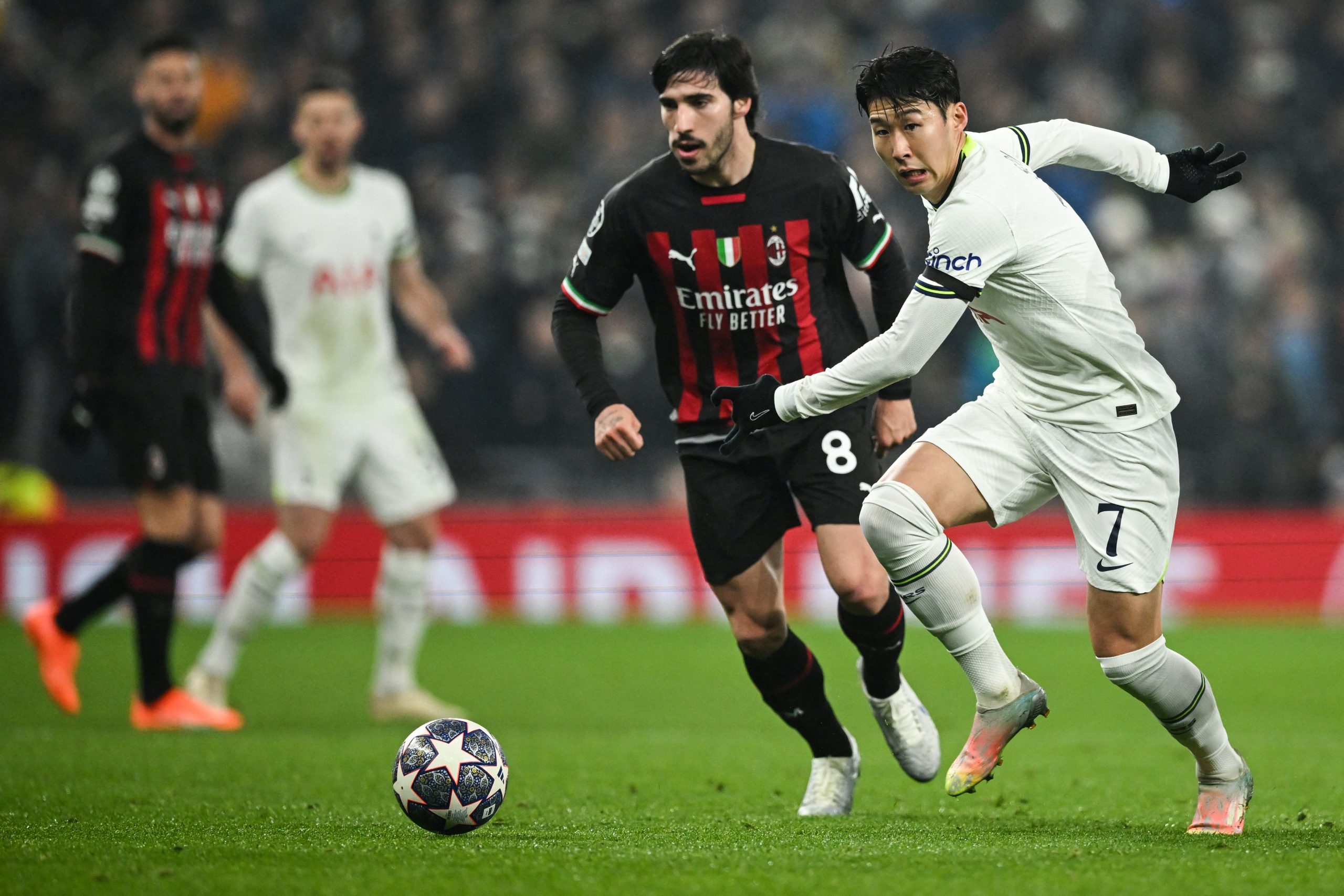 Tottenham Hotspur's South Korean striker Son Heung-Min runs with the ball past AC Milan's Italian midfielder Sandro Tonali.