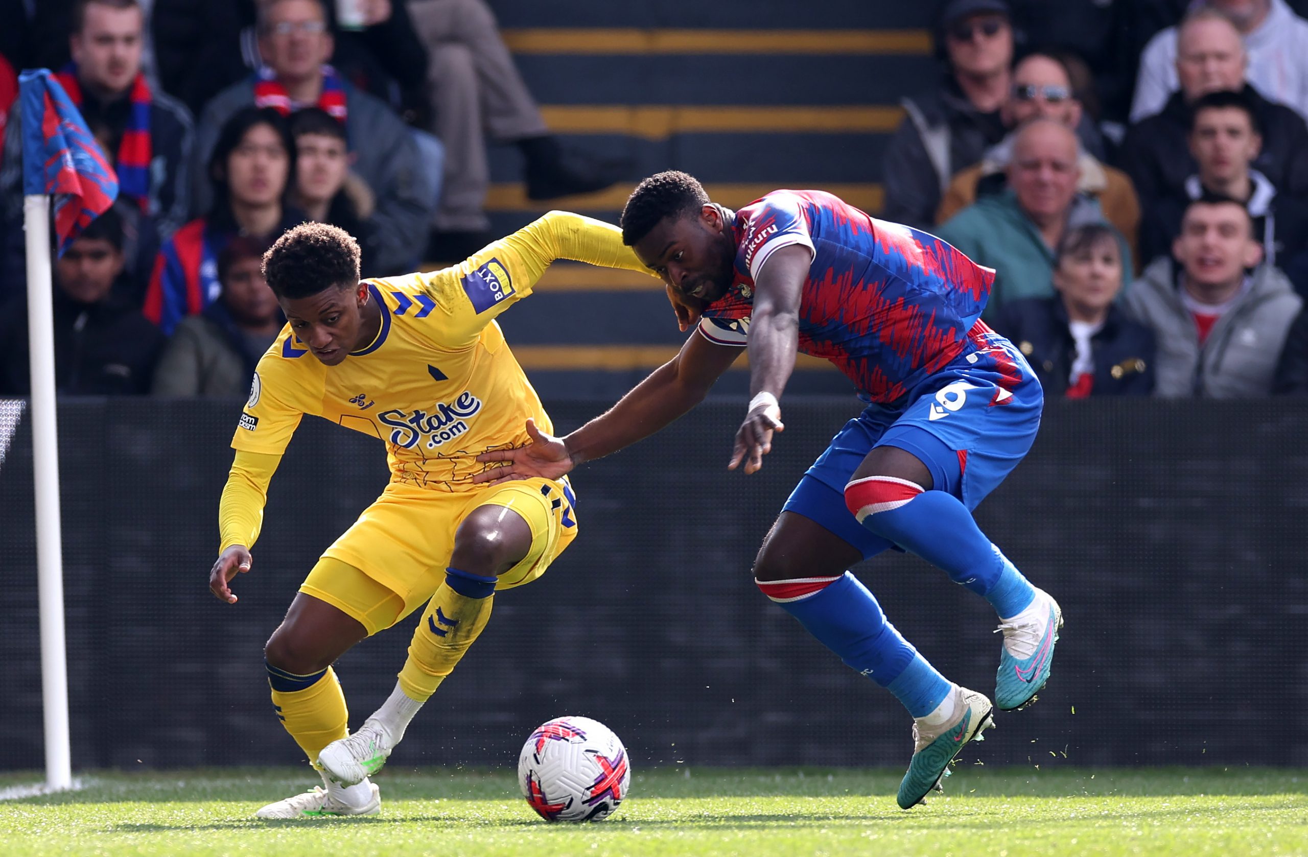 emarai Gray is challenged by Marc Guehi of Crystal Palace.