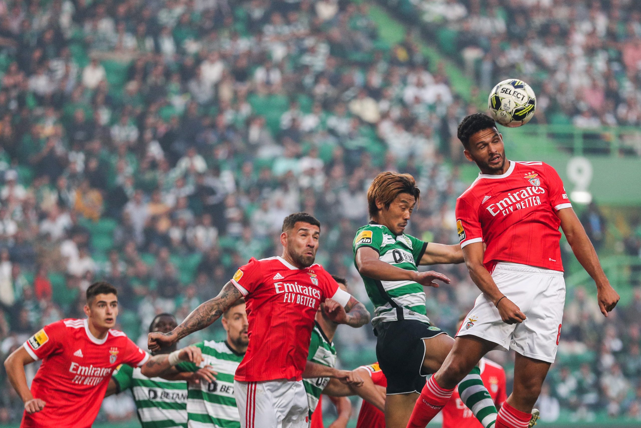 Benfica's Portuguese forward Goncalo Ramos (R) heads the ball next to Sporting's Japanese midfielder Hidemasa Morita.