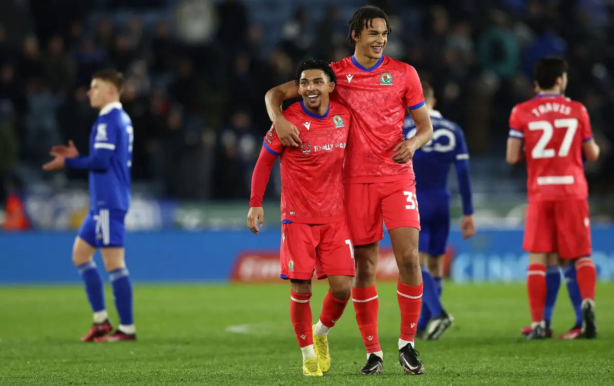 Blackburn Rovers' English midfielder Tyrhys Dolan (C) and Ashley Phillips celebrate.