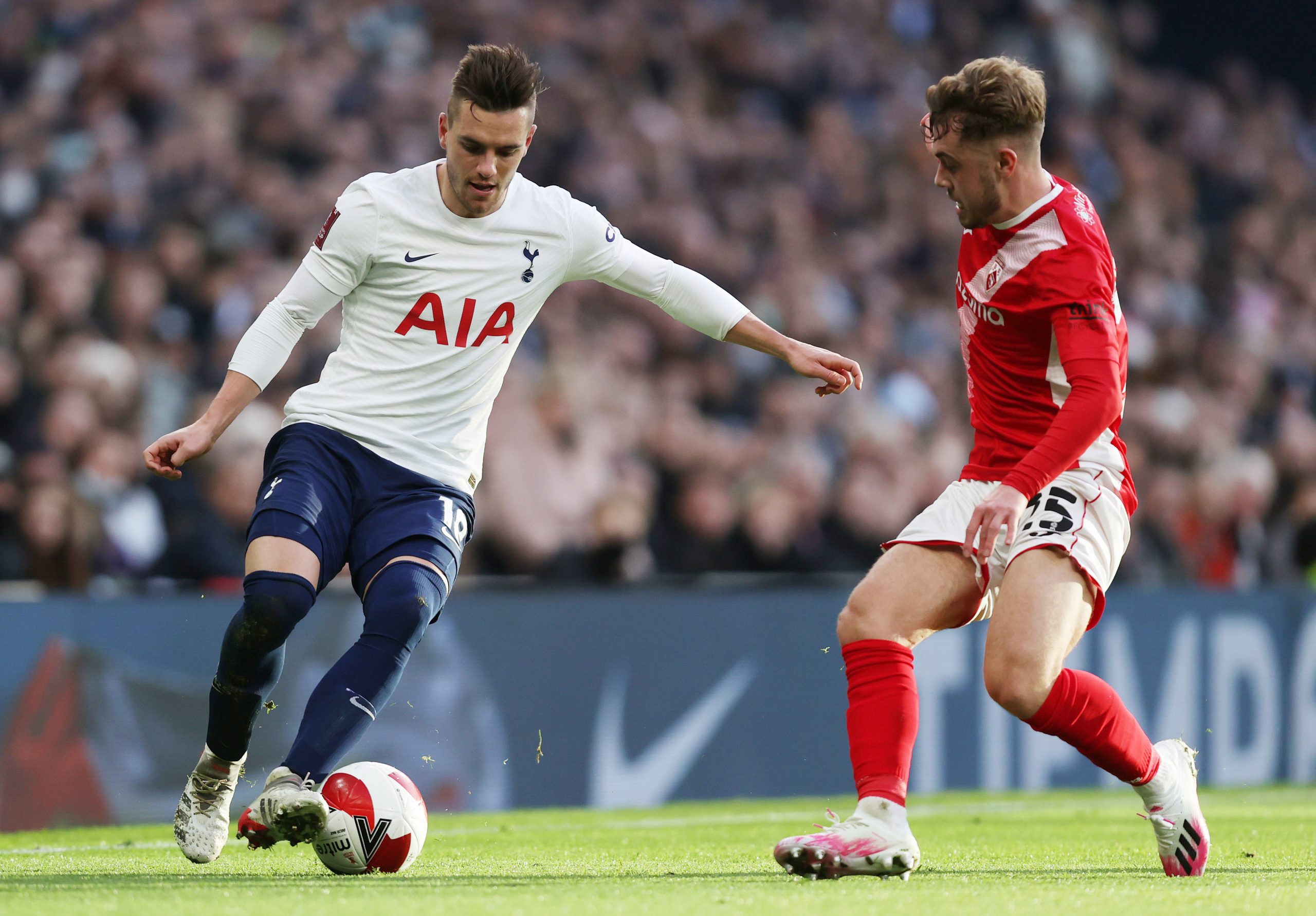 Giovani Lo Celso of Tottenham Hotspur is challenged by Alfie McCalmont of Morecambe.