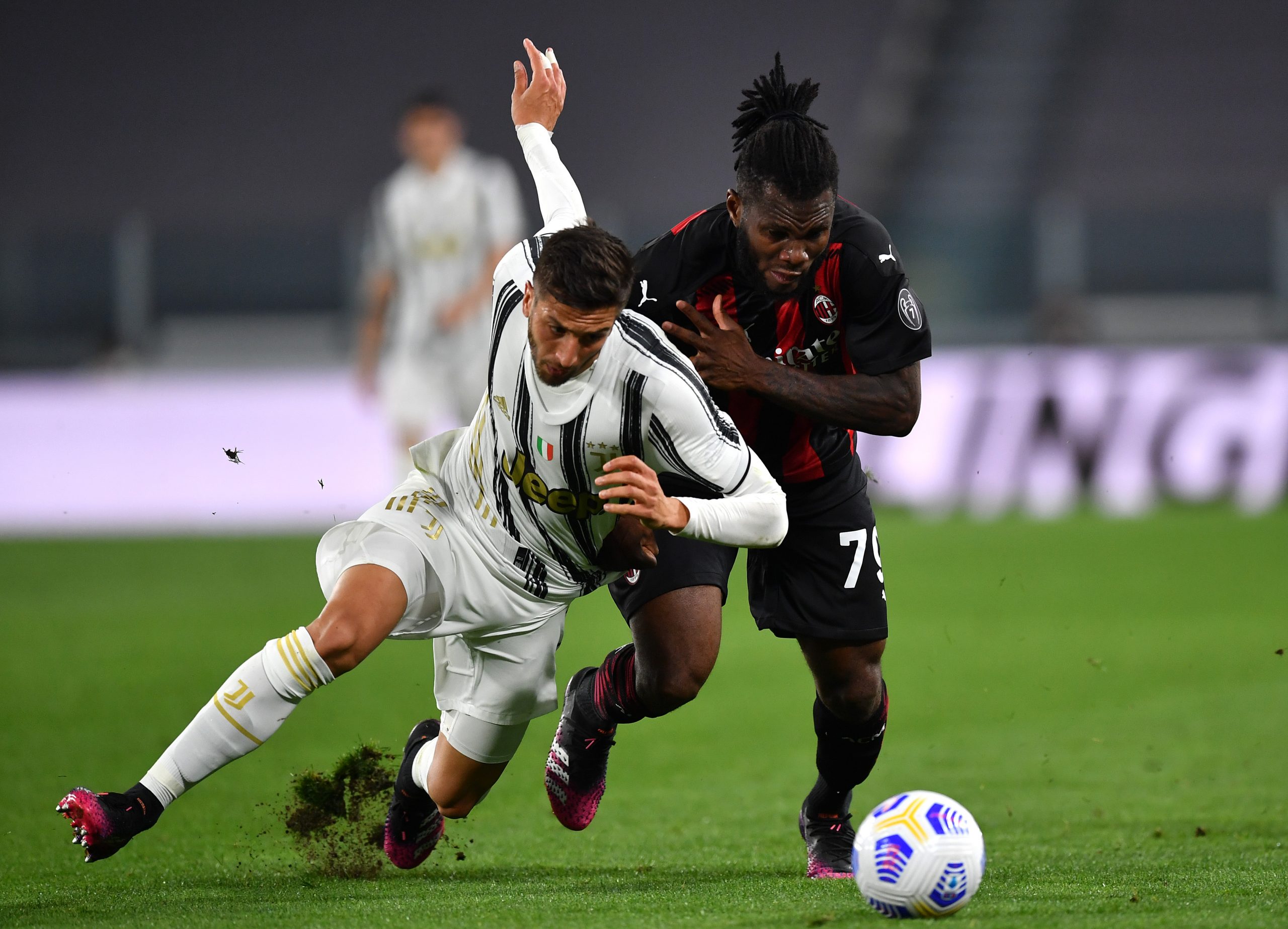 Rodrigo Bentancur of Juventus is challenged by Franck Kessie of AC Milan.